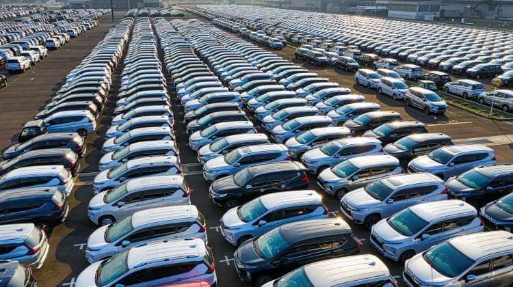 New cars parked in rows on manufacturer's parking lot