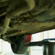 Looking up at underside of a car on a lift