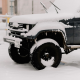 Left-Front quarter view of a black Jeep covered in snow.