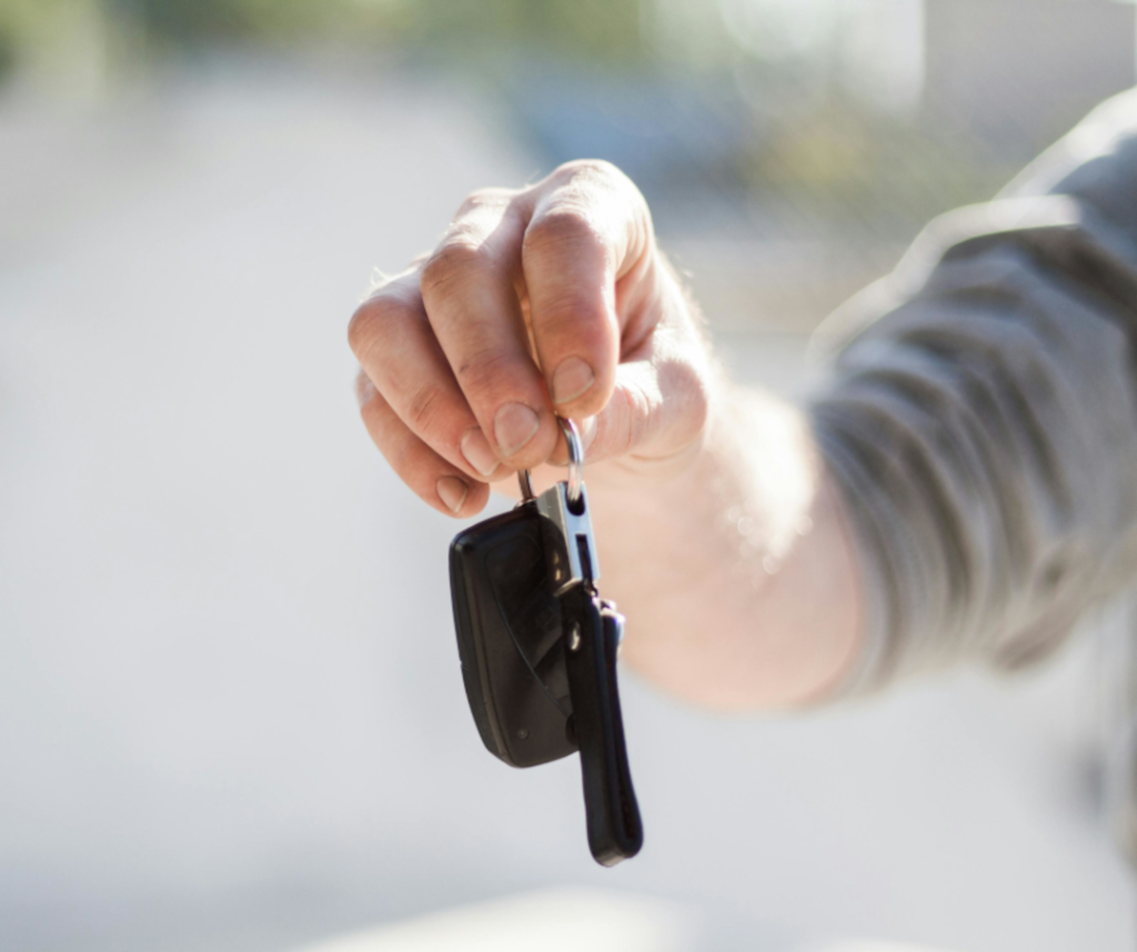 Hand holding car key